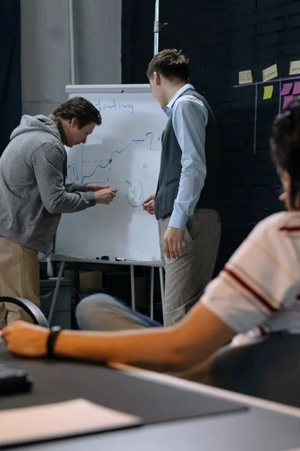Close-up of a person writing on a business strategy document with a pen.